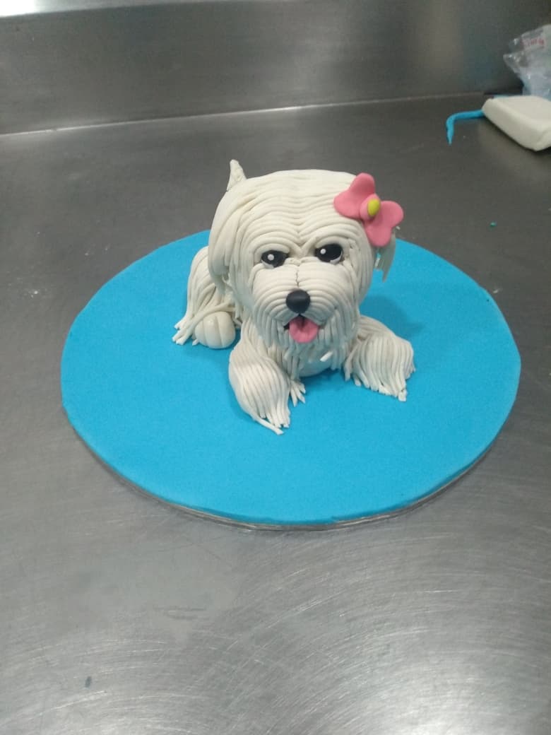 Hand-sculpted white dog cake topper