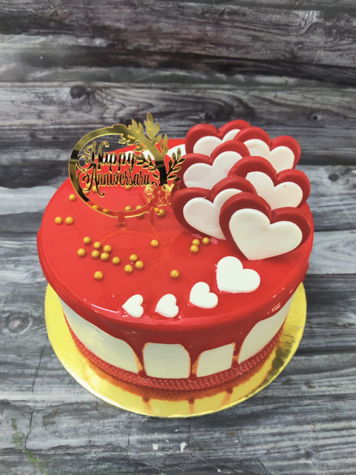 Anniversary cake with red mirror glaze and hearts