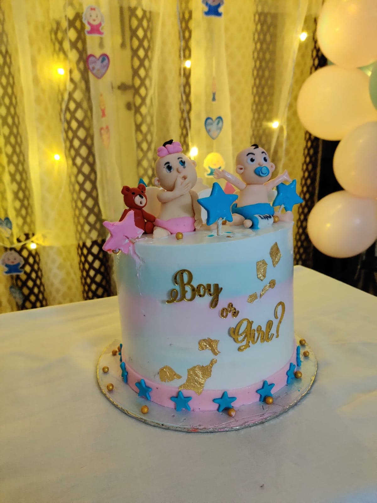 Gender reveal cake with boy or girl topper