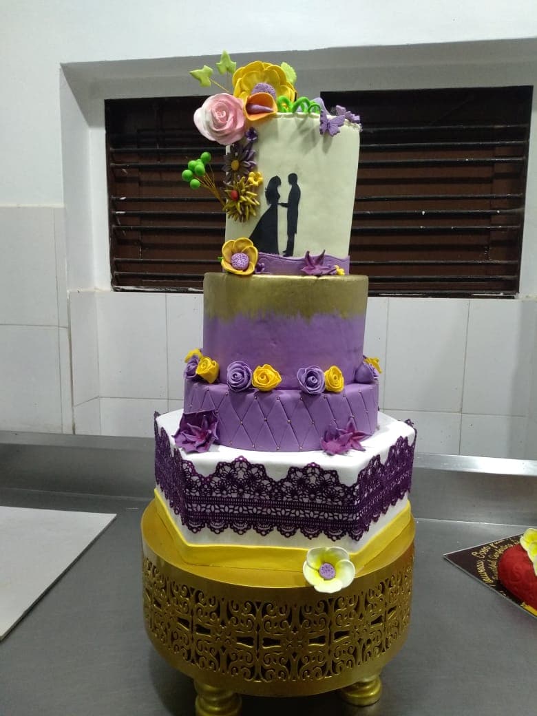 Four-tier purple and gold wedding cake